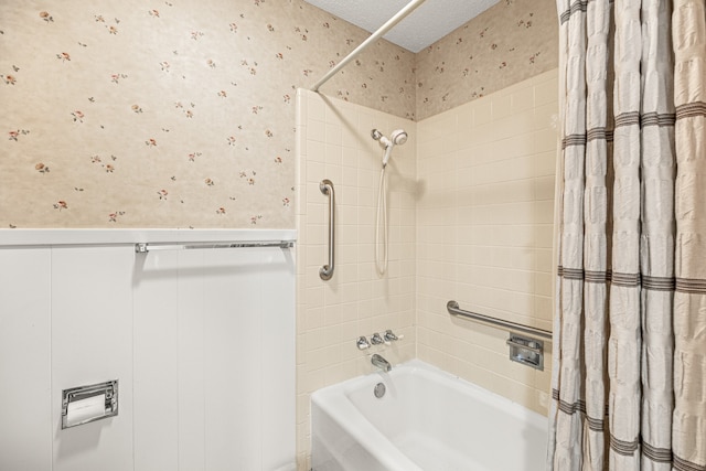 bathroom with a textured ceiling and shower / bath combo