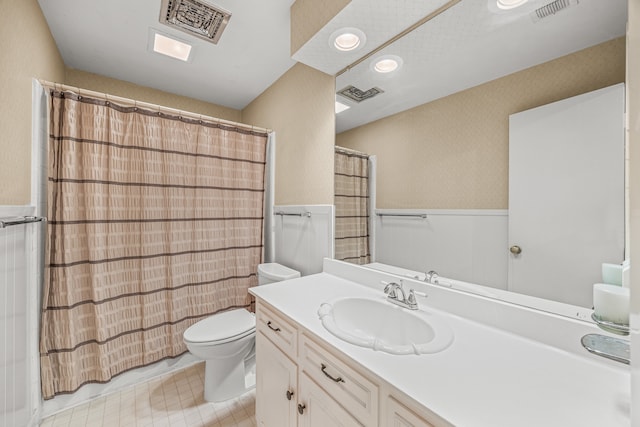 bathroom featuring vanity, toilet, and curtained shower