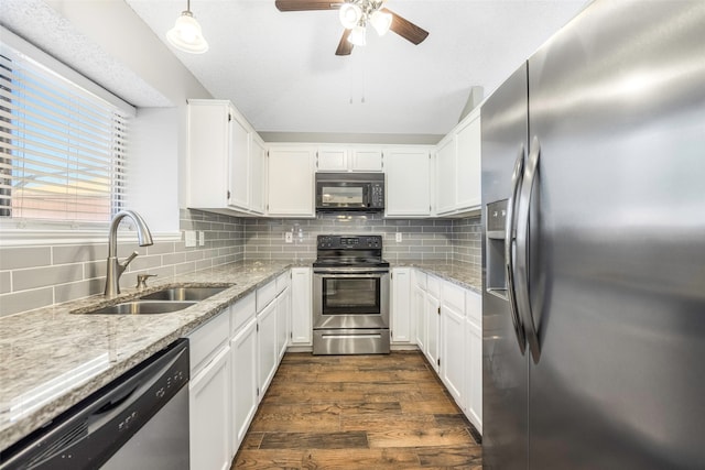 kitchen featuring white cabinetry, sink, tasteful backsplash, dark hardwood / wood-style floors, and appliances with stainless steel finishes