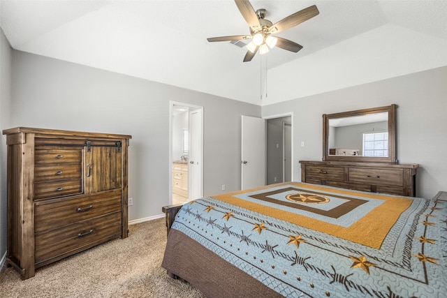 bedroom with carpet flooring, ensuite bathroom, vaulted ceiling, and ceiling fan