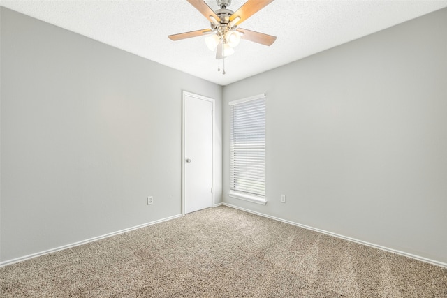 spare room with carpet flooring, ceiling fan, and a textured ceiling