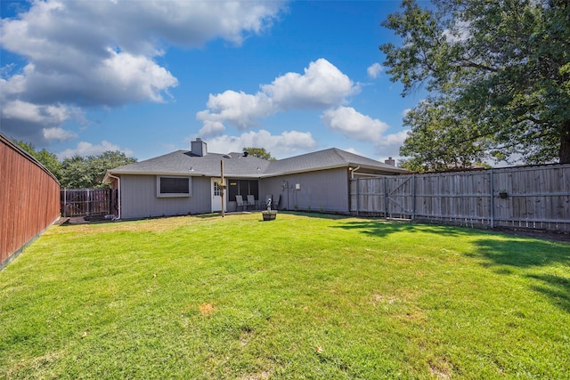 back of property with a lawn