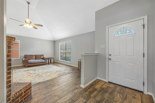 foyer featuring dark hardwood / wood-style flooring, ceiling fan, and lofted ceiling