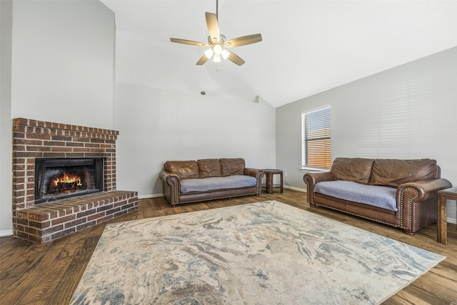 living room featuring ceiling fan, wood-type flooring, lofted ceiling, and a brick fireplace