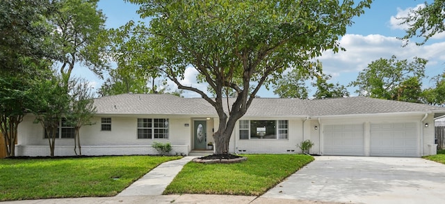 single story home featuring a front lawn and a garage