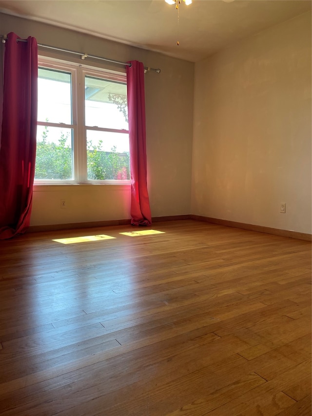 unfurnished room featuring ceiling fan and light hardwood / wood-style floors