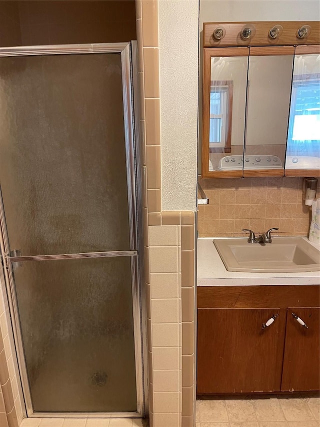 2633 State Highway 59 N, Bowie, TX 76230 - bathroom featuring a stall shower, tile walls, tile patterned floors, and vanity