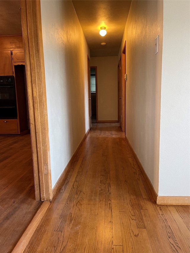 corridor with light wood-type flooring