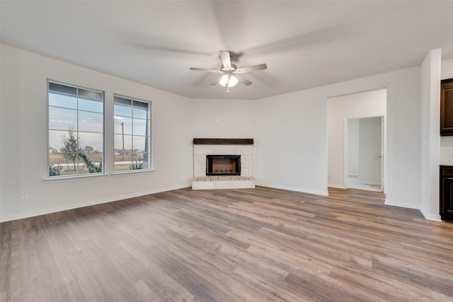 unfurnished living room featuring light wood-type flooring and ceiling fan