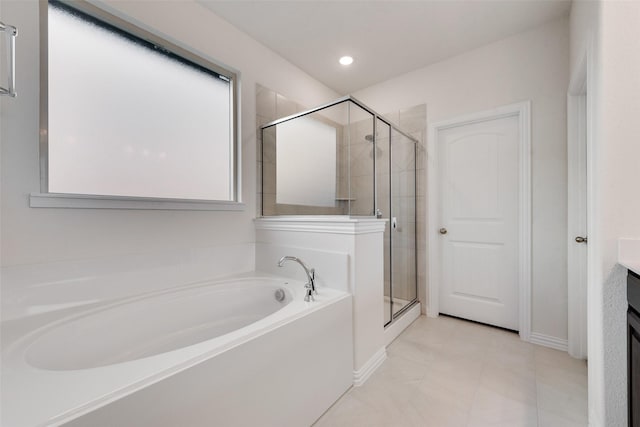 bathroom with vanity, shower with separate bathtub, and a wealth of natural light