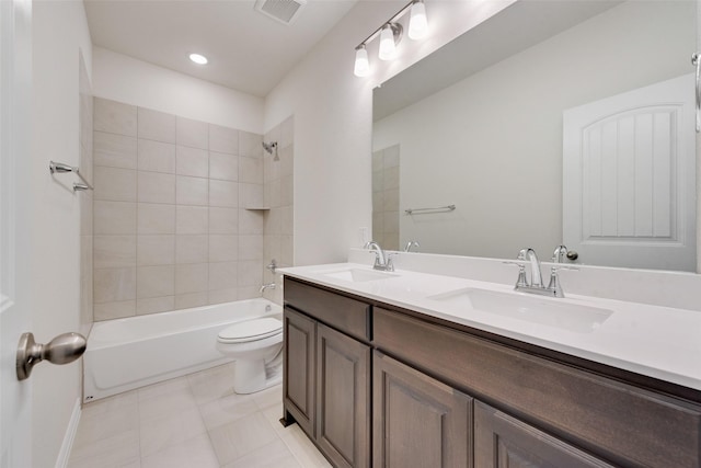 full bathroom featuring tiled shower / bath combo, toilet, and vanity