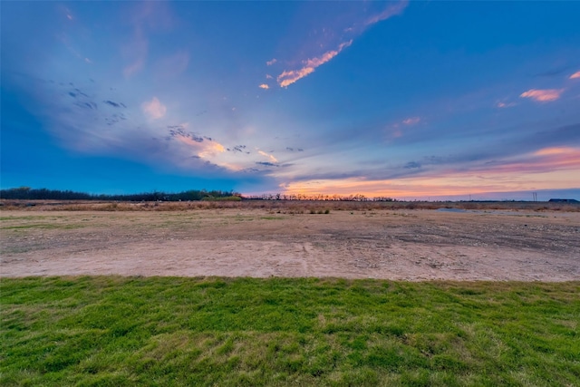 yard at dusk with a rural view