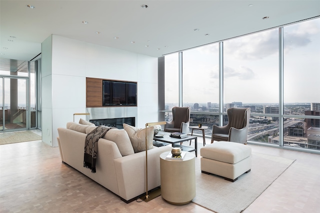 living room with a healthy amount of sunlight and floor to ceiling windows