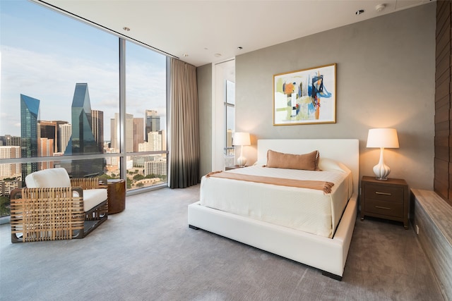 bedroom featuring expansive windows and carpet