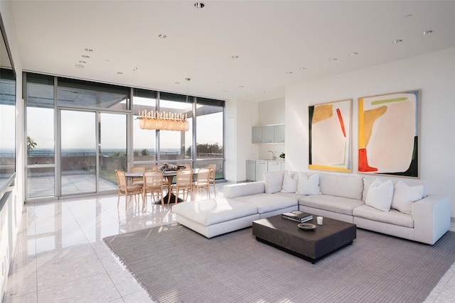 tiled living room with sink and a wall of windows