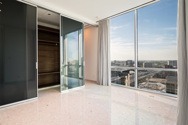 unfurnished bedroom featuring a closet and floor to ceiling windows