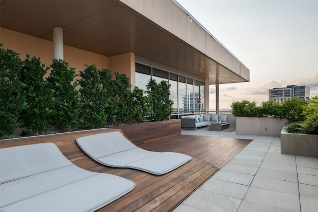 deck at dusk with outdoor lounge area