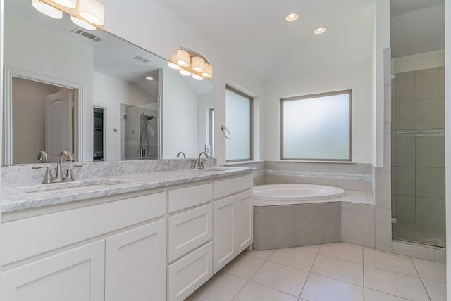 bathroom featuring vanity, plus walk in shower, and tile patterned floors