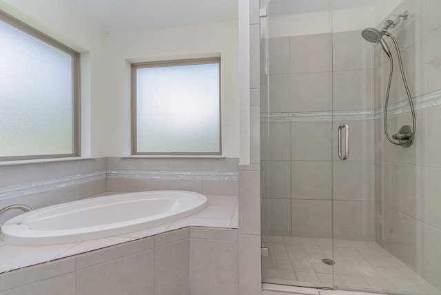 bathroom with shower with separate bathtub