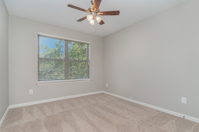 carpeted empty room featuring ceiling fan