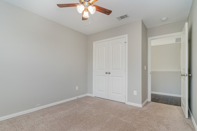 unfurnished bedroom with a closet, ceiling fan, and carpet