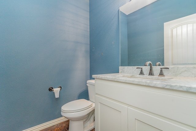 bathroom featuring vanity, toilet, and wood-type flooring