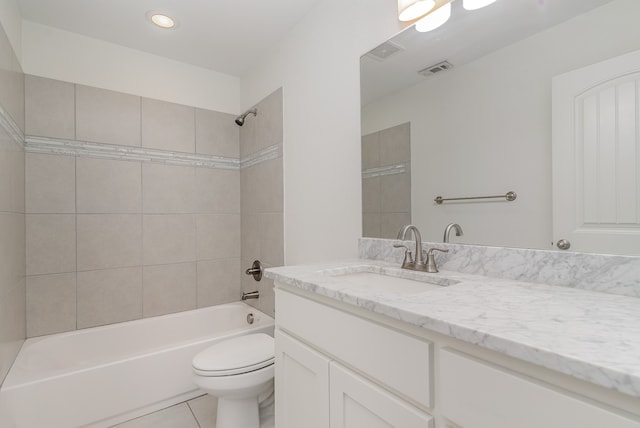 full bathroom featuring vanity, toilet, tile patterned flooring, and tiled shower / bath