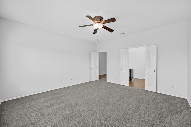 unfurnished bedroom featuring ceiling fan and carpet floors