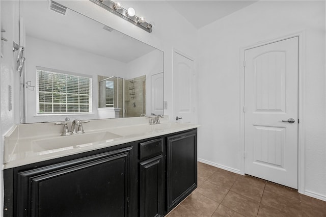 bathroom with tile patterned floors, vanity, and a shower with shower door