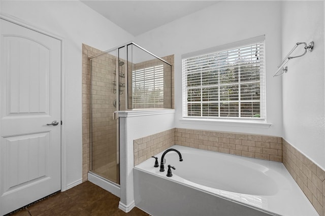 bathroom with a wealth of natural light, plus walk in shower, and tile patterned floors