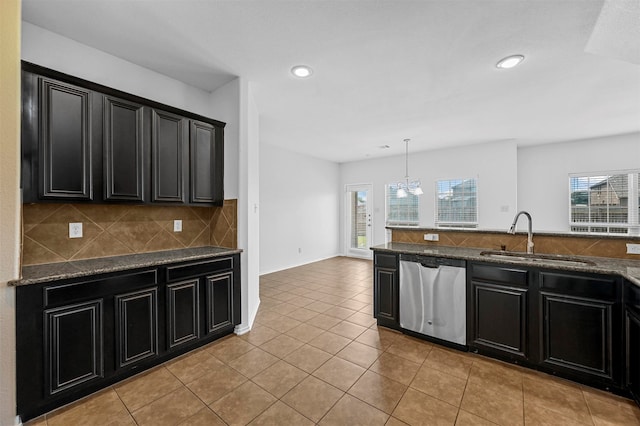 kitchen with hanging light fixtures, dishwasher, an inviting chandelier, sink, and light tile patterned flooring