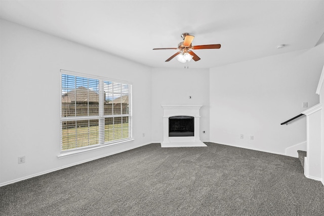 unfurnished living room featuring dark carpet and ceiling fan