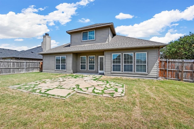 back of property with a yard and a patio