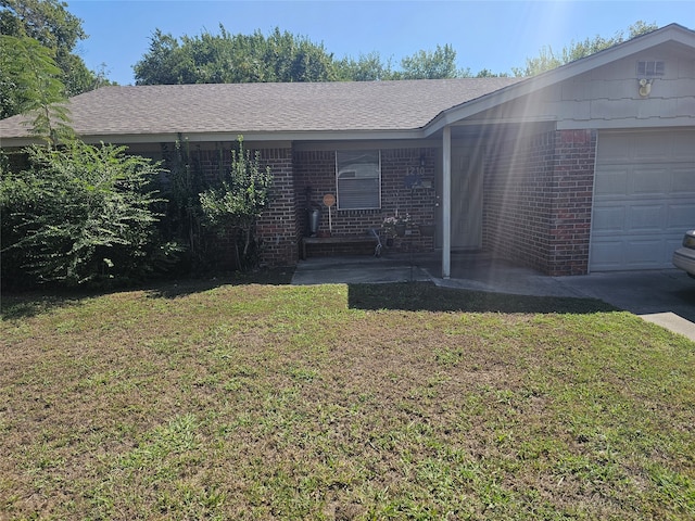 view of front of property with a front yard and a garage