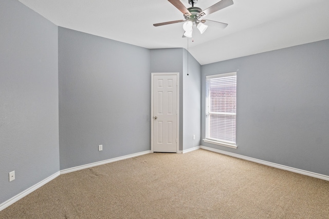 spare room with lofted ceiling, carpet, and ceiling fan