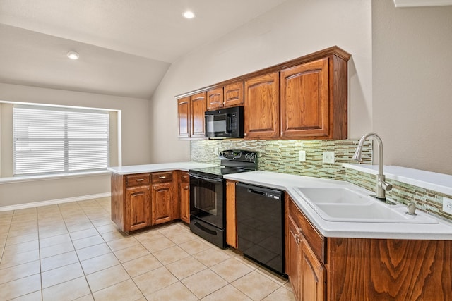 kitchen with vaulted ceiling, sink, black appliances, kitchen peninsula, and tasteful backsplash