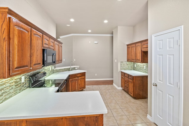 kitchen featuring light tile patterned floors, sink, kitchen peninsula, stove, and tasteful backsplash