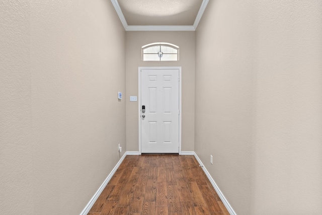 doorway to outside with ornamental molding and wood-type flooring