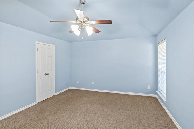 carpeted spare room with ceiling fan