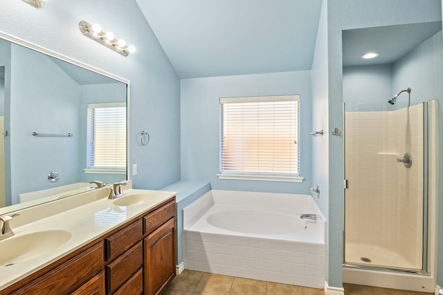 bathroom with vanity, vaulted ceiling, plus walk in shower, and tile patterned floors