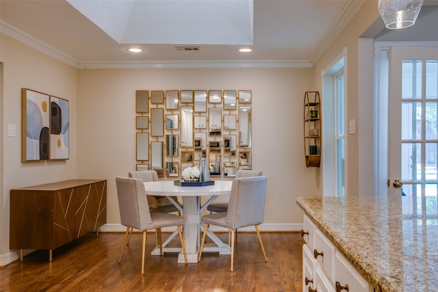 dining room featuring dark hardwood / wood-style floors and crown molding