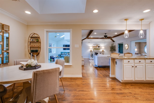 dining area with ornamental molding, light hardwood / wood-style flooring, ceiling fan, and a wealth of natural light