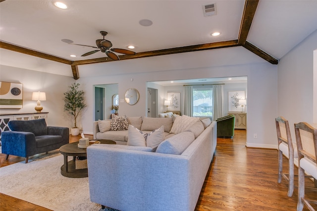 living room with hardwood / wood-style floors, ceiling fan, and lofted ceiling with beams