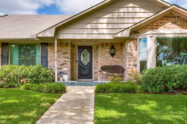 entrance to property featuring a yard