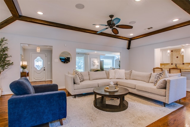 living room with ceiling fan and dark hardwood / wood-style flooring