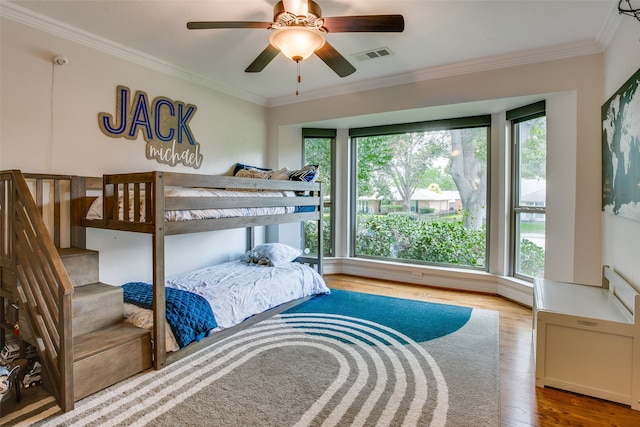 bedroom featuring ornamental molding, hardwood / wood-style flooring, and ceiling fan