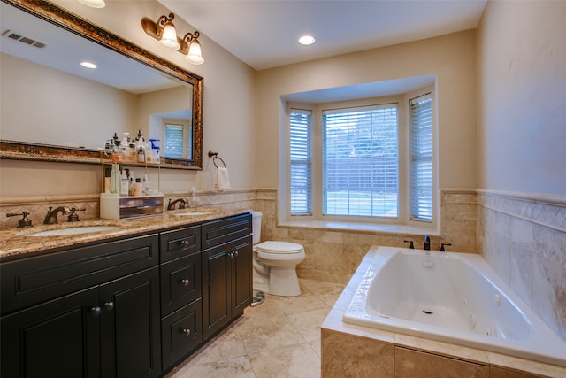 bathroom with tile patterned flooring, toilet, tiled bath, and vanity