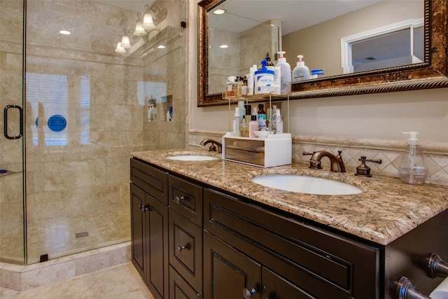 bathroom with tile patterned flooring, a shower with door, and vanity