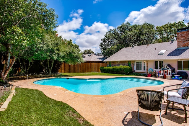 view of swimming pool featuring area for grilling, a lawn, and a patio