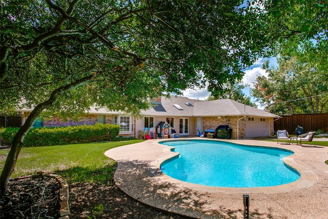 view of swimming pool featuring a yard and a patio